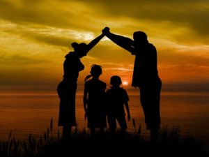 Adoption vs surrogacy img: family enjoying sunset