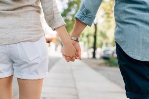 an infertile man and woman couple | holding hand together