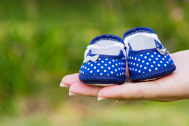 Baby Shoes in hands to give denotes surrogacy