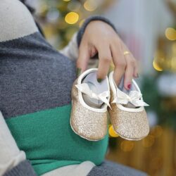 Pic: Pregnant lady with baby shoes for post What if something unfortunate happens to the surrogate mother?
